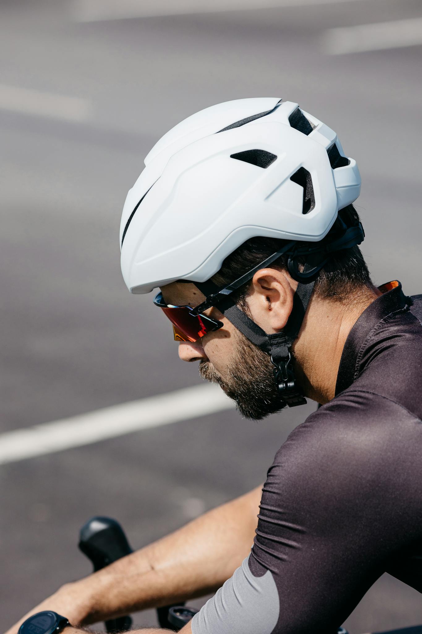 A man wearing a helmet and sunglasses on a bike