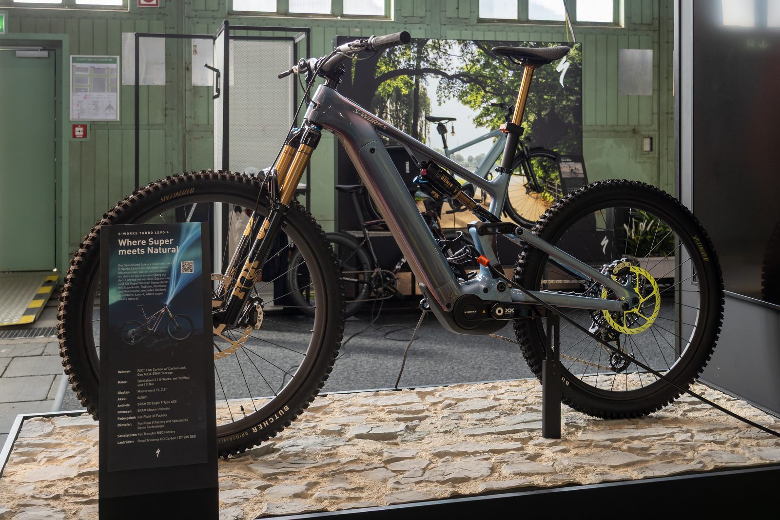 A Specialized S-Works Turbo Levo 4 electric mountain bike on a show display stand.